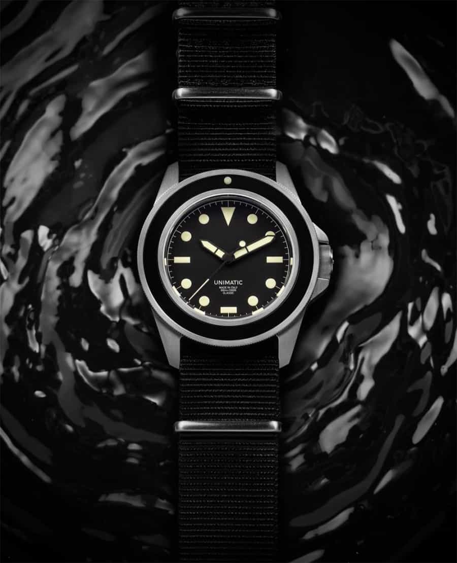 Men's black Unimatic watch laid out