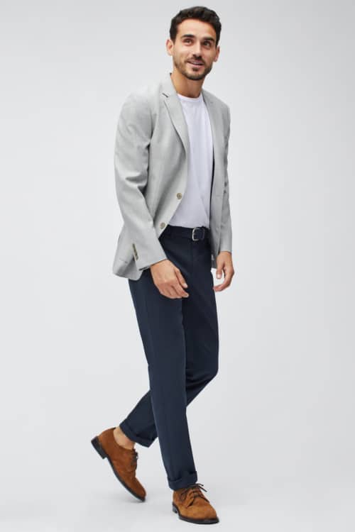 Men's navy chinos, white T-shjirt, grey blazer and tan suede shoes outfit