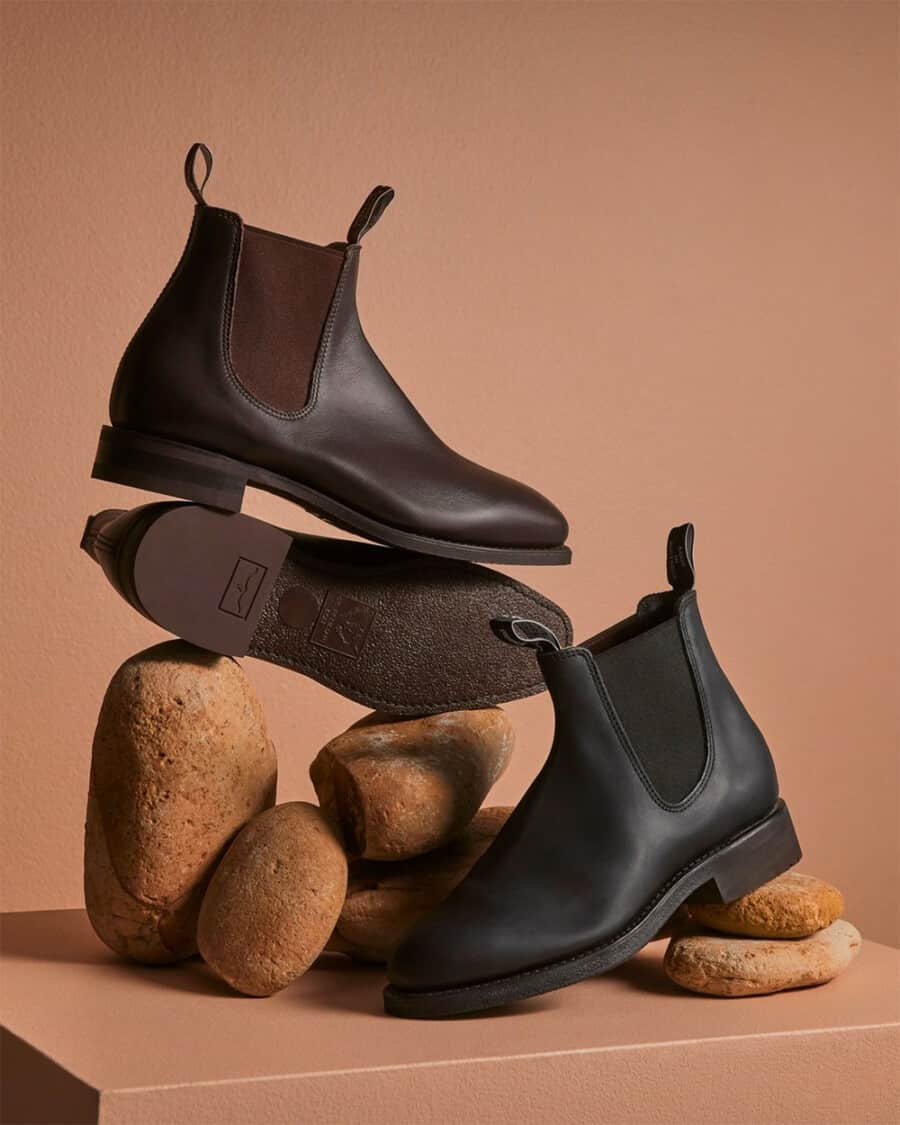 A selection of R.M. Williams men's Chelsea boots balanced on rocks