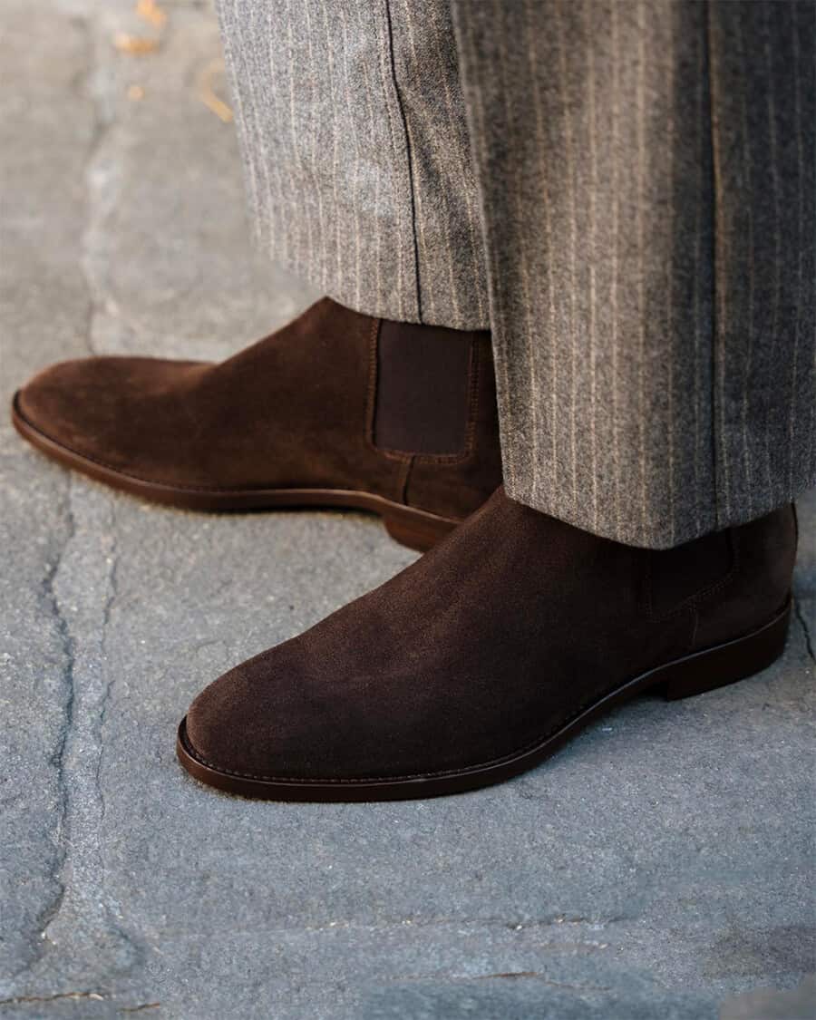 Man wearing brown suede Chelsea boots with grey wool pinstripe trousers