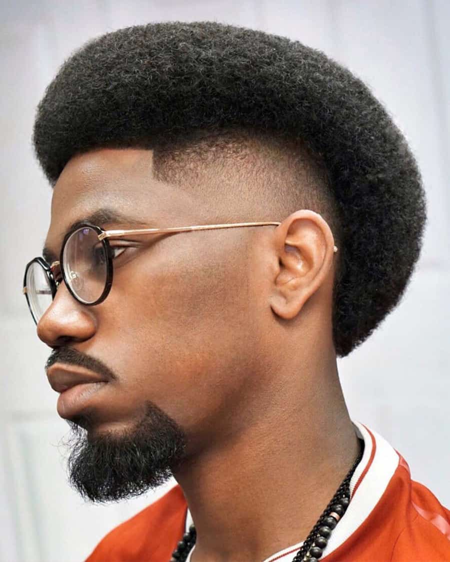 Black man with mullet afro and high faded sides