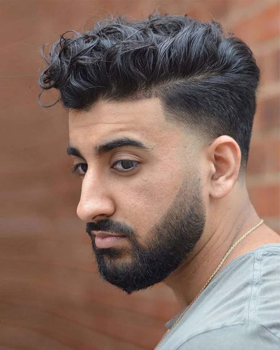 Mid-length wavy haircut with low fade