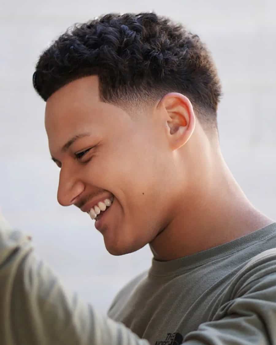 Men's soft curly haircut with low fade