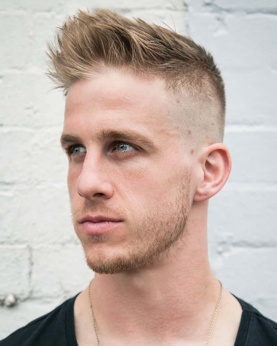 Man with a longer length high and tight haircut with high bald fade