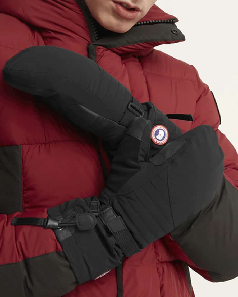 Man wearing technical mitts/mittens and a down ski jacket