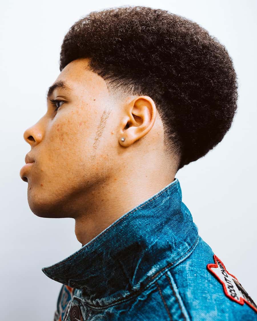 Black man with smooth rounded afro and low fade