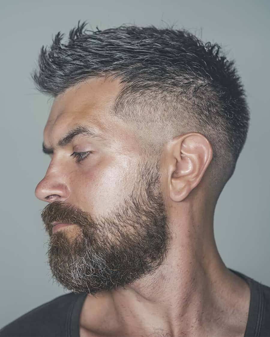 Men's short haircut with low bald fade