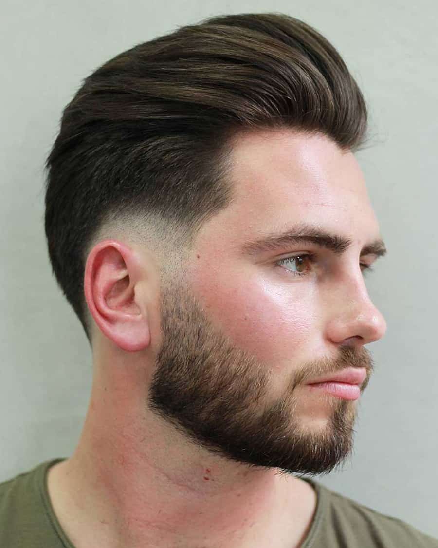 Men's swept back hairstyle with low fade