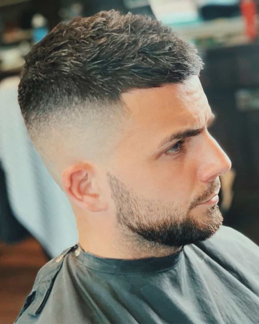Man with short textured hairstyle with a high bald fade