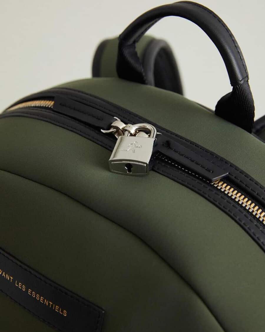 Close up of a luxury green men's backpack with silver lock detailing