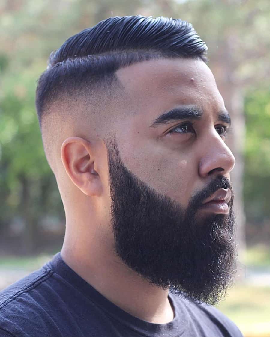 Asian man with a dark comb over fade haircut and full beard