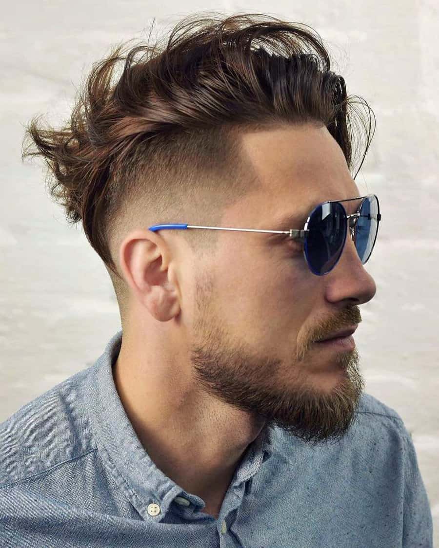 Long length, messy comb over fade hairstyle with undercut