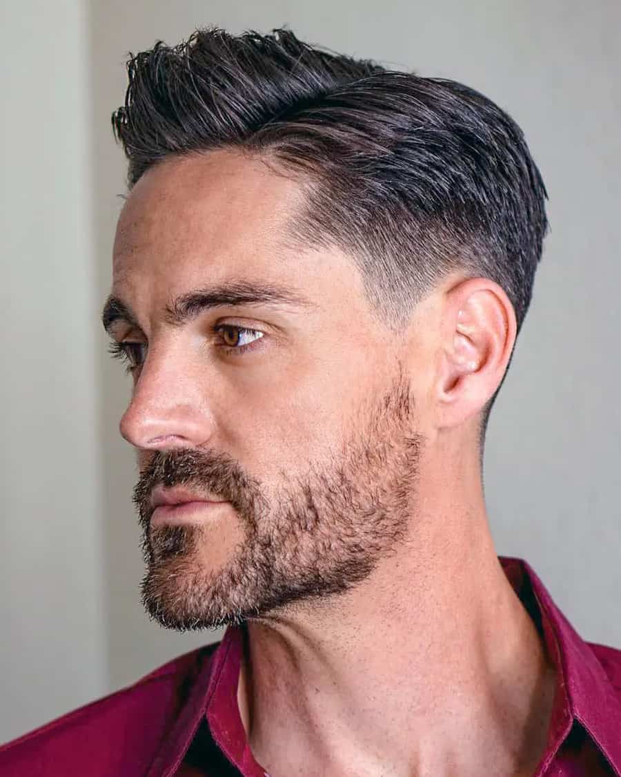 MAture man with classic comb over hairstyle with a low taper fade