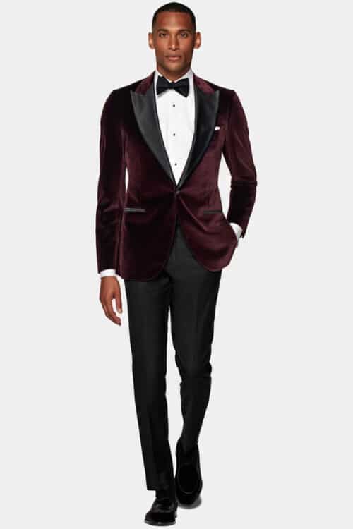Men's black tie attire with a twist. Dinner jacket switched for a burgundy velvet jacket