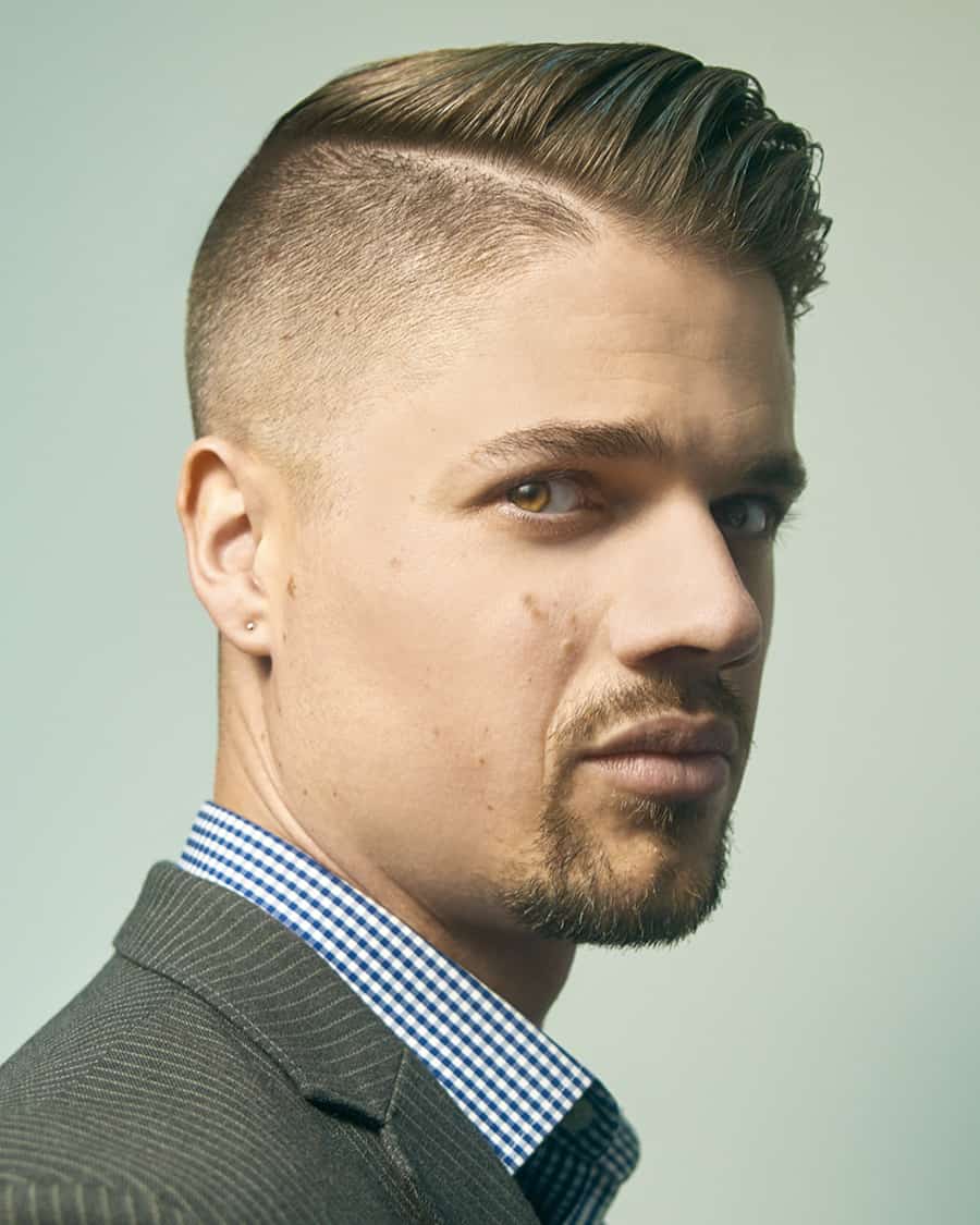 Men's slick side part comb over haircut with a fade