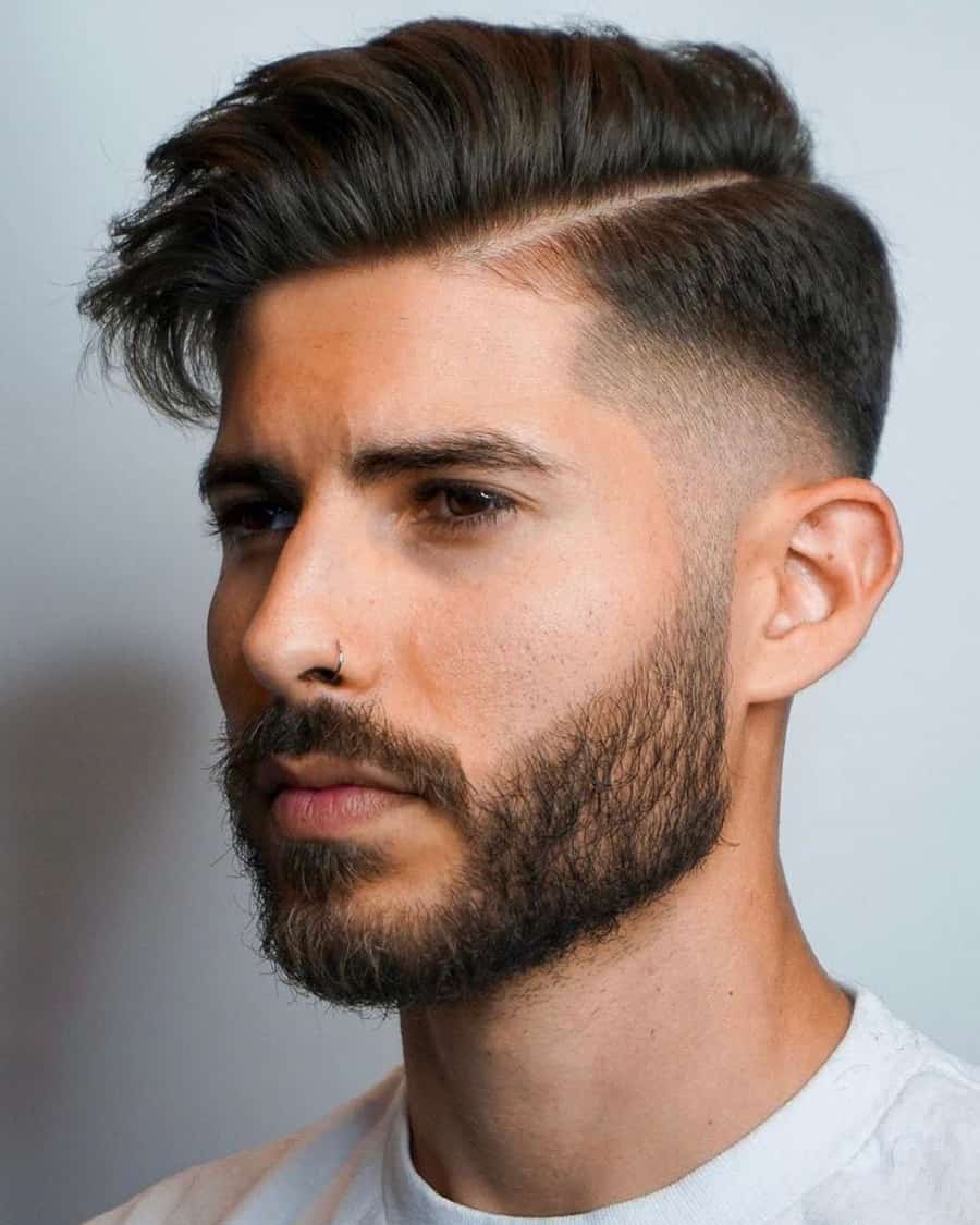 Men's side sweep comb over haircut with a temple fade