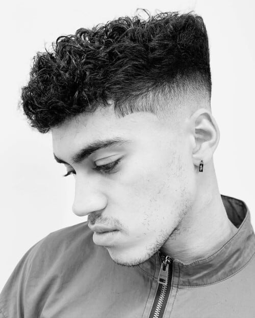 Man with curly French crop/modified high top with skin fade