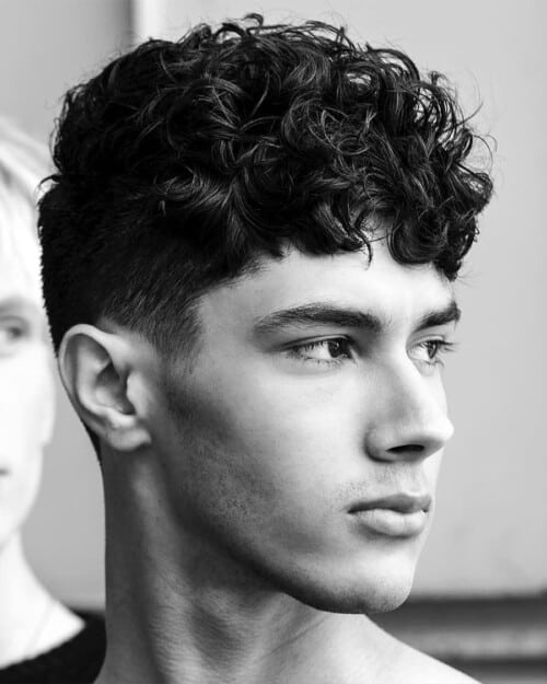 Man with a short curly hair French crop haircut