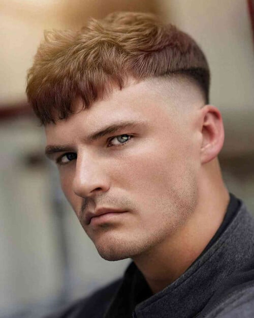 Man with a disconnected French crop haircut and skin fade