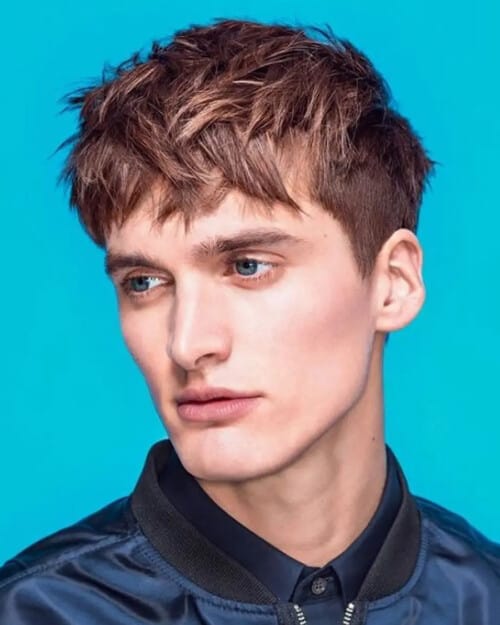 Men's long length, choppy French crop haircut with highlights