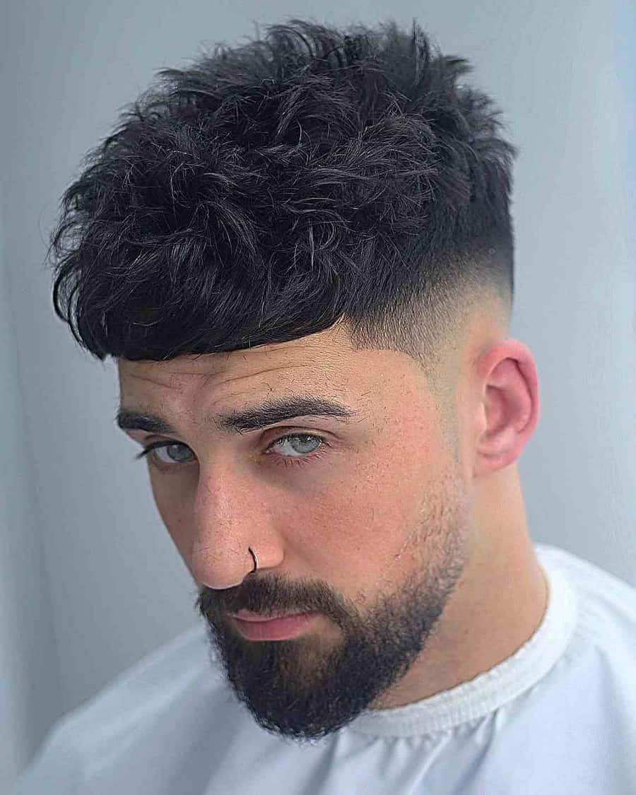 Man with a messy, French crop haircut and high skin fade