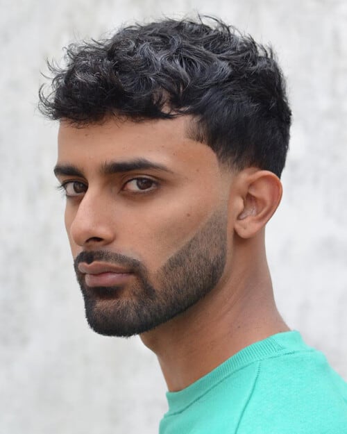 Indian man with a short, textured French crop hairstyle