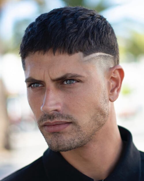 Man with short French crop haircut with hart parting and skin fade