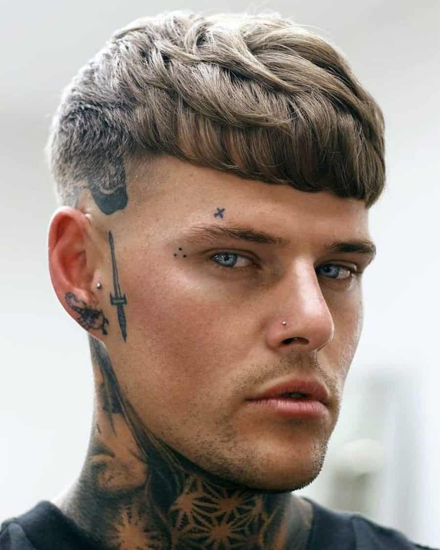 Man with mid-length hair wearing a French crop hairstyle with skin fade