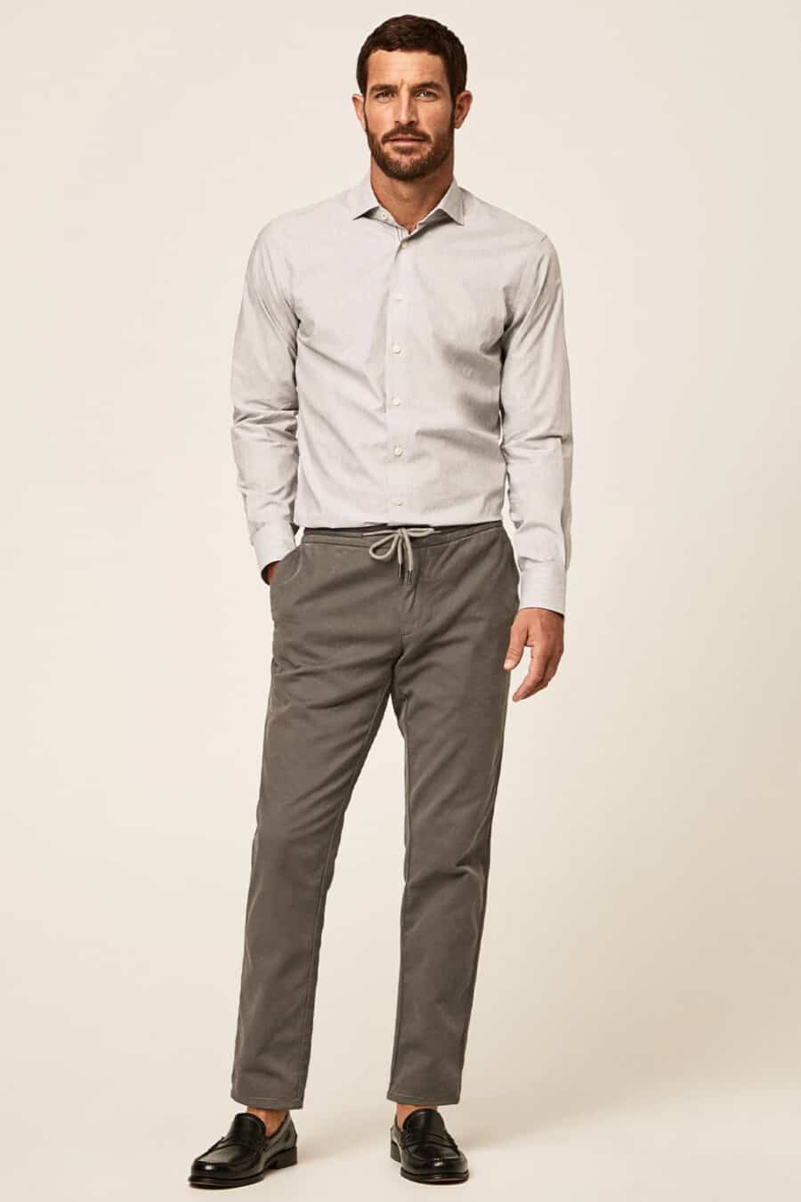 Men's grey drawstring pants, light grey shirt and black leather loafers outfit