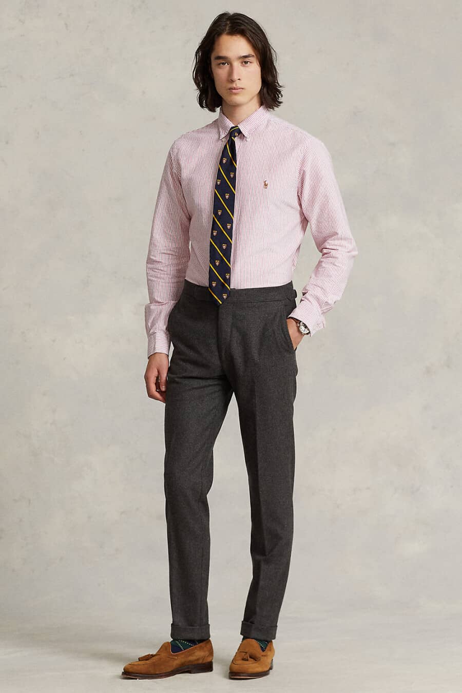 Men's charcoal dress pants, pink striped dress shirt, navy and yellow club tie and tan suede loafers outfit
