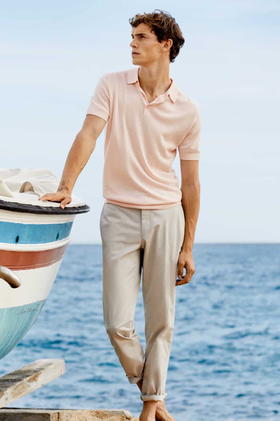 Men's washed pink polo shirt and light grey chinos outfit