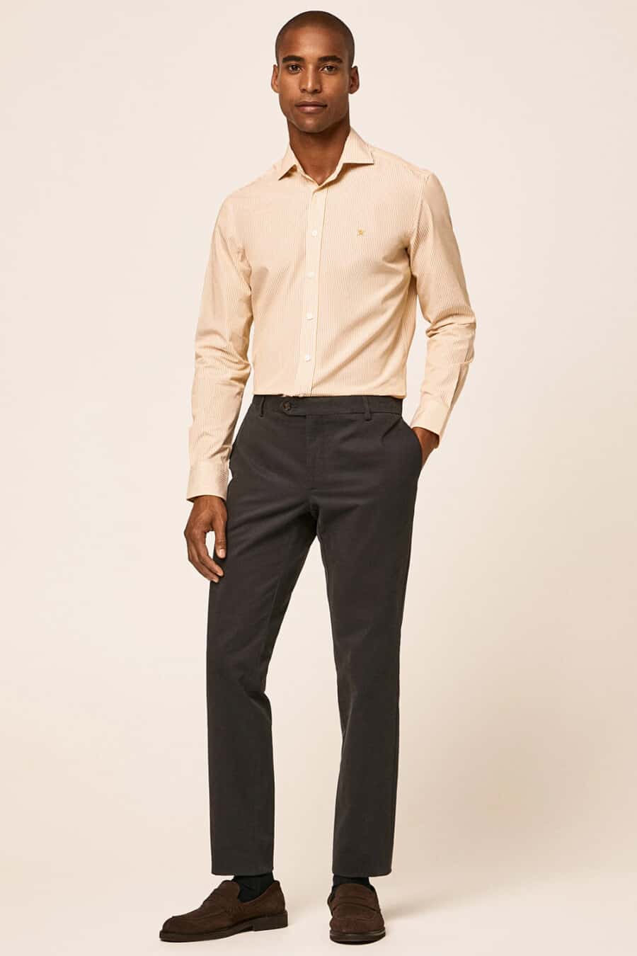 Men's dark grey chinos, light yellow dress shirt and brown suede loafers outfit