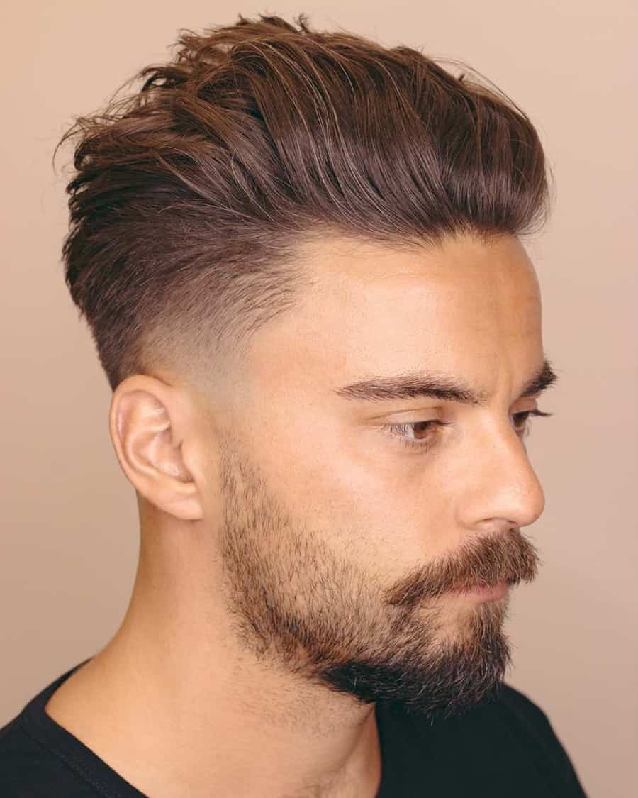 Man with a messy, volumised pompadour and high taper fade haircut