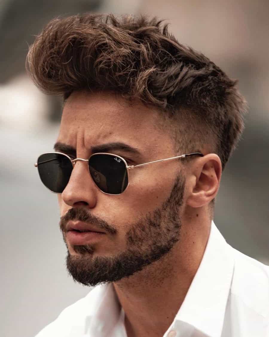 Man with high, textured pompadour and a high taper fade
