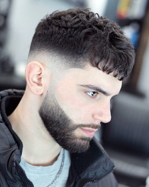 Man with a Caeser haircut and high taper fade