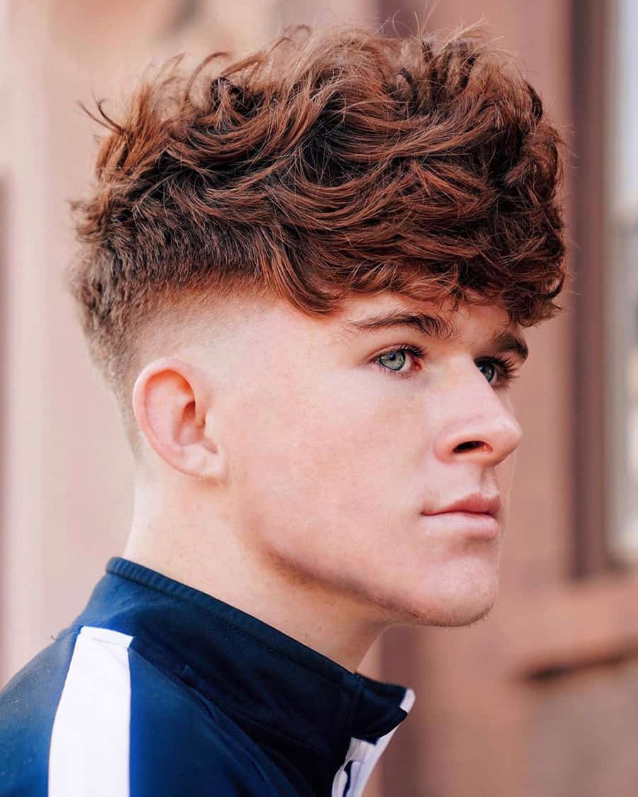 Man with thick, wavy mop and high taper fade haircut