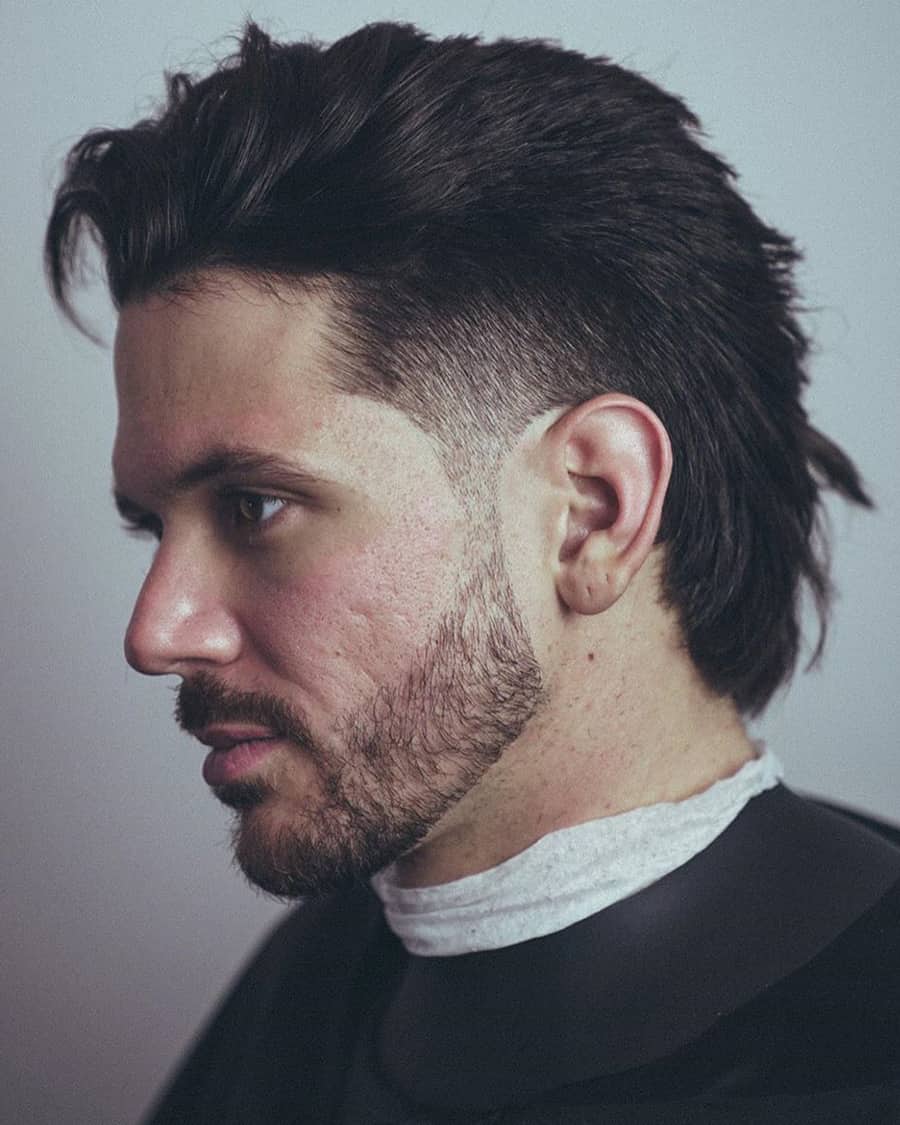 Modern mullet hairstyle for men with a temple fade