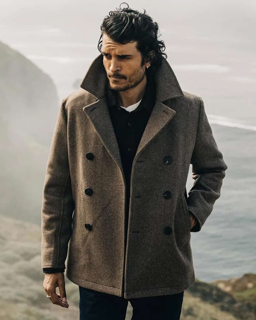 Man wearing a brown wool peacoat in great outdoors