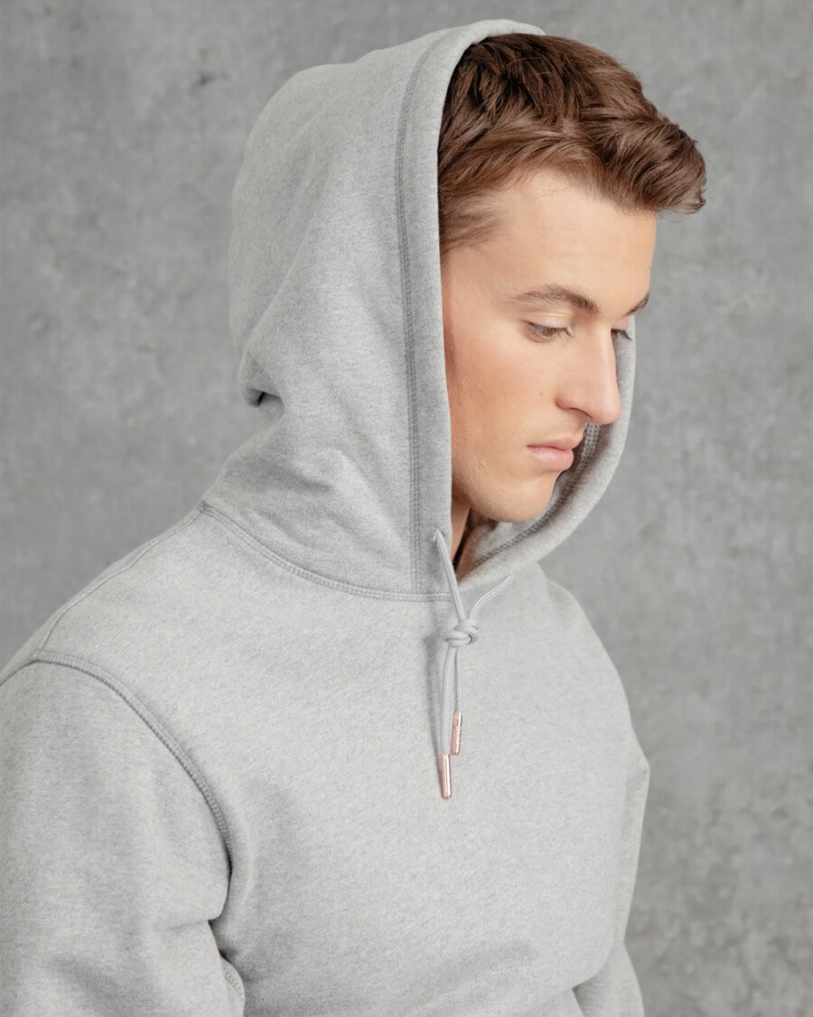 Man wearing a heavyweight grey Private White V.C. hoodie