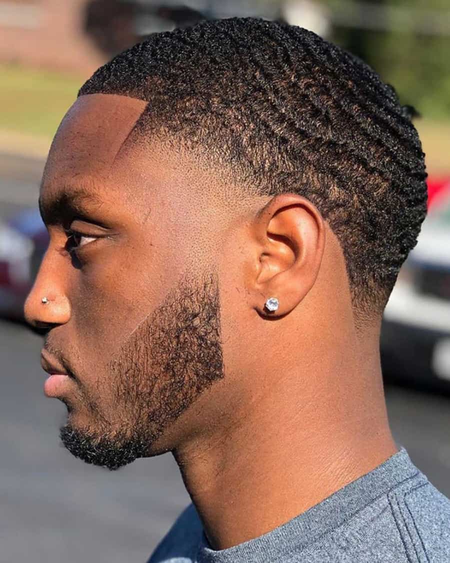 Black man with short buzz cut waves and a temple fade