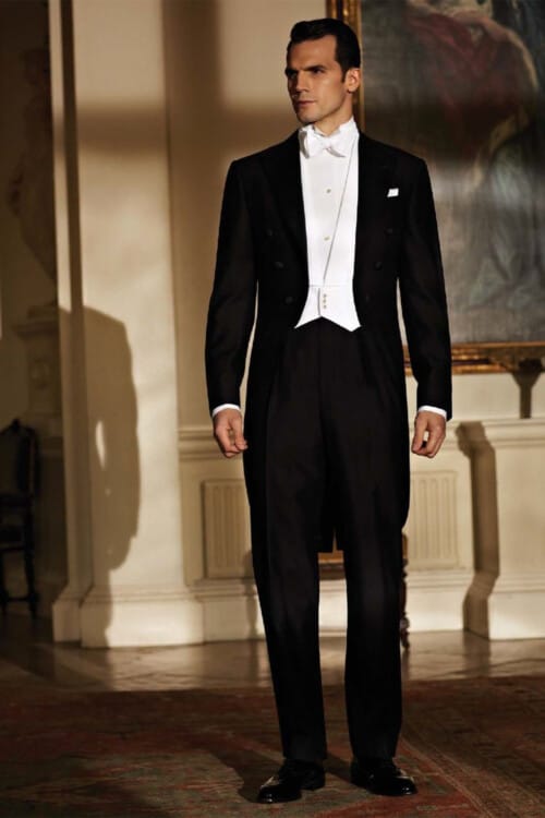 Man attending a formal event in white tie tails