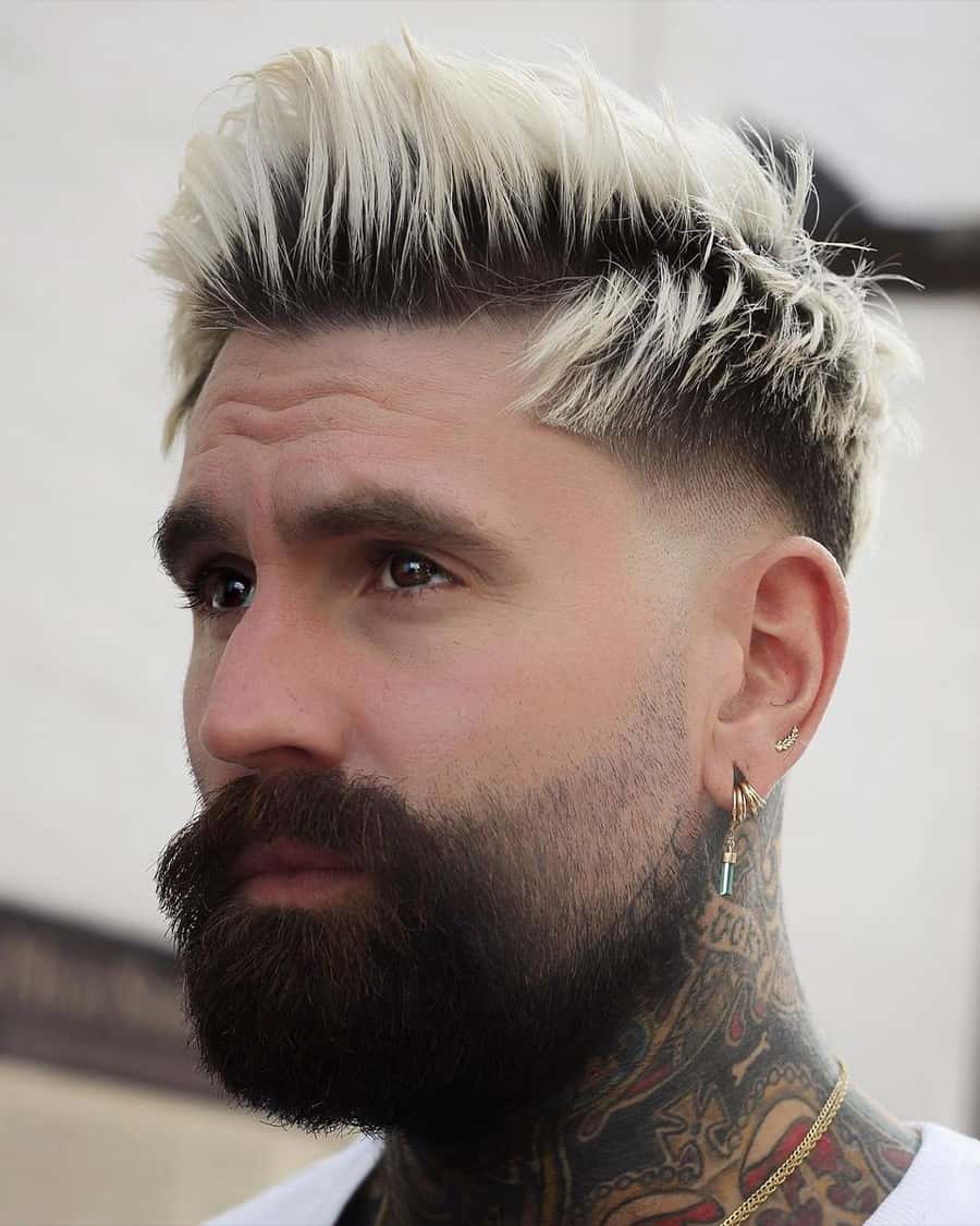 Men's bleached blonde faux hawk hairstyle with drop fade