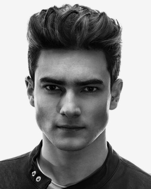 Man with thick black hair and high pompadour hairstyle