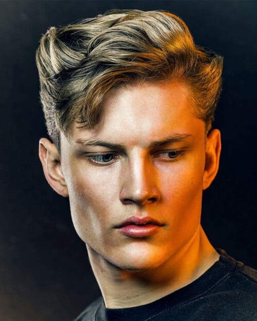 Man with thick blonde hair wearing a quiff