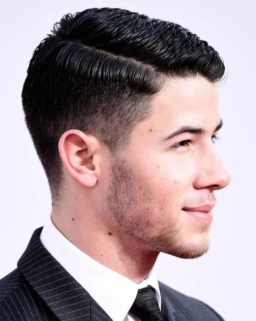 Joe Jonas with a thick, wavy side parting hairstyle
