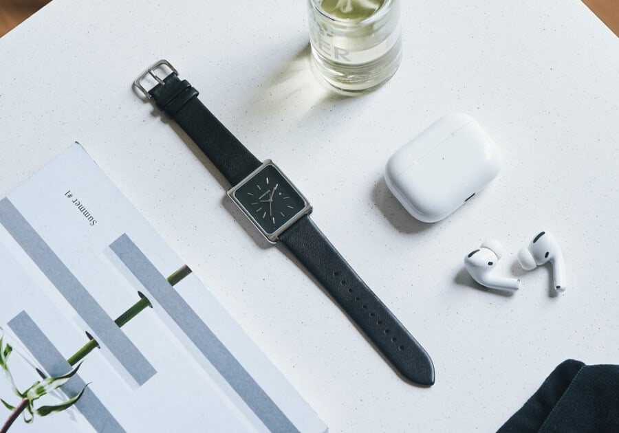Minimalist rectangle Monofore watch laid out on table