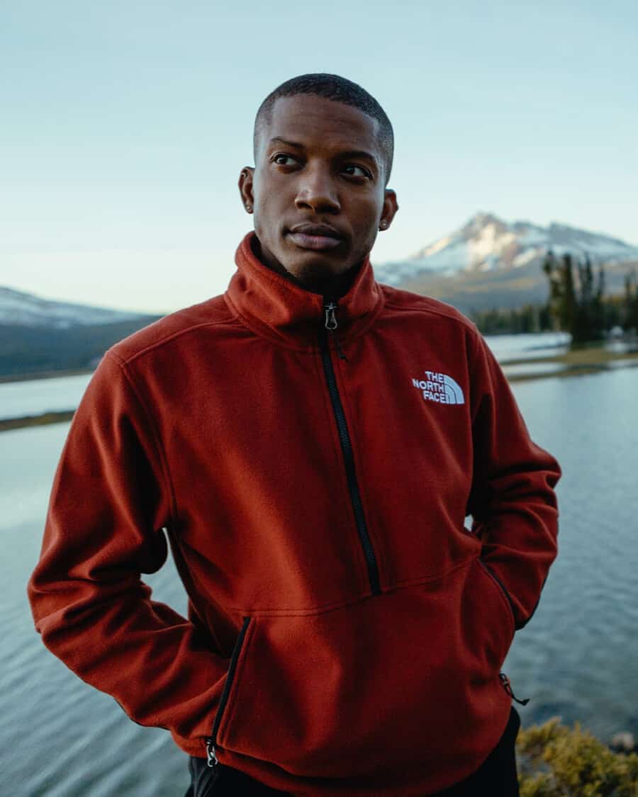 Man wearing a red North Face iconic fleece jacket outside