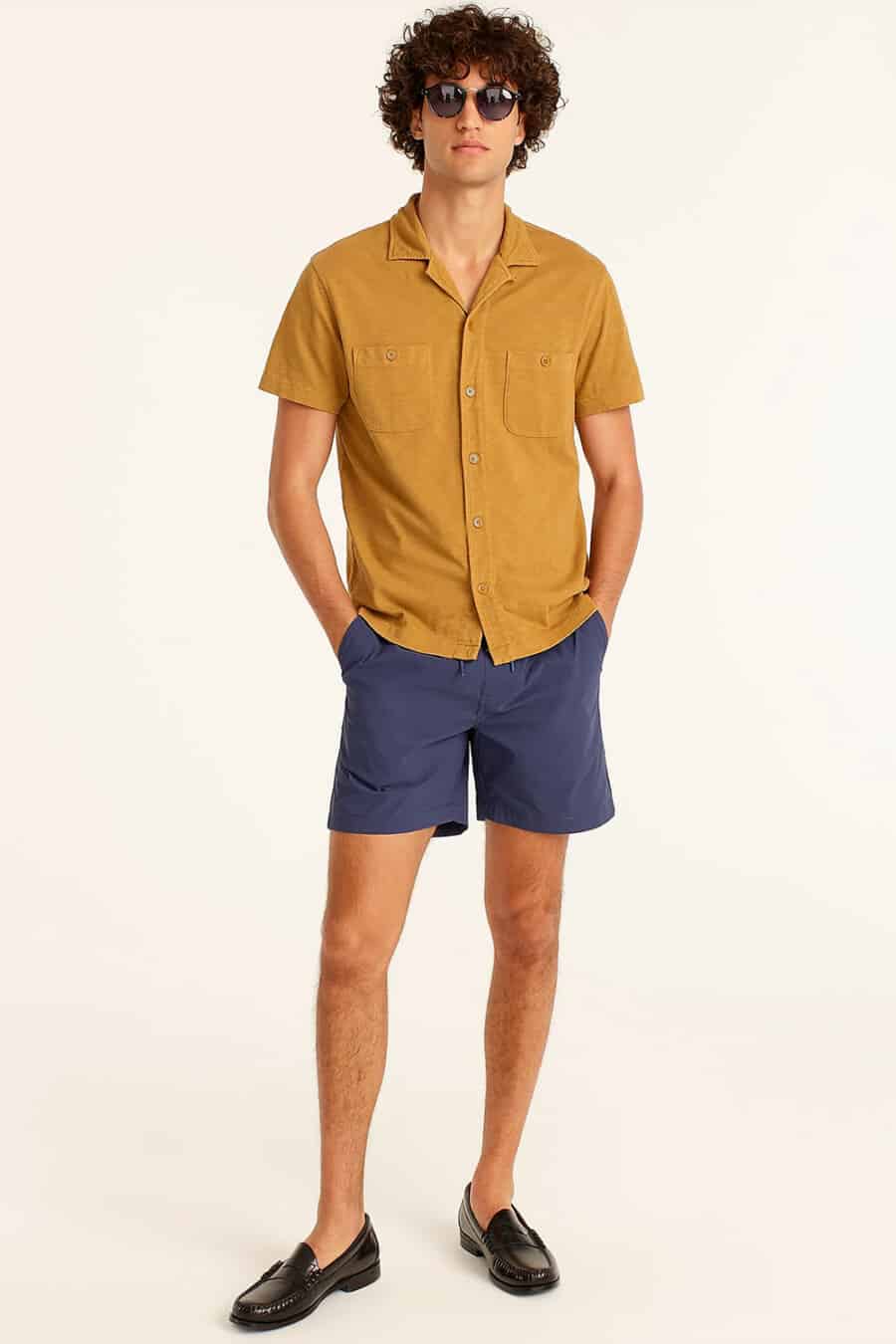 Men's navy swim shorts, yellow short sleeve Cuban collar shirt and black leather penny loafers outfit
