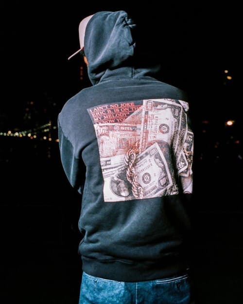 Man wearing Stussy hoodie with print on back