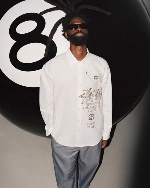 Man wearing a relaxed fitting white Stussy shirt